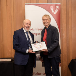 Zoli Somlyai, from Age Concern Canterbury, receiving his Award on stage