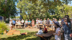 A large group of people standing in a semi-circle around musical instruments