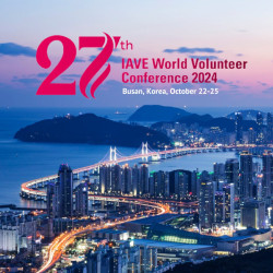 An nighttime, aerial photo of the city of Busan, Korea. Text reads "27th IAVE World Volunteer Conference 2024, Busan, Korea, October 22-25"