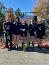 Five St Andrews College students standing with spades and gumboots