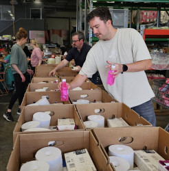 Staff members from EY volunteering at 0800 Hungry packing food parcels