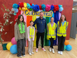 Selwyn District Mayor Sam Broughton at the Selwyn CultureFest, with VolCan volunteers from Clearview Primary School