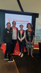 Five members of the VolCan team, standing together outside the entrance to the VNZ Hui