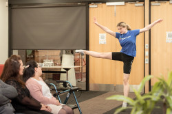 A girl dances while the audience looks on