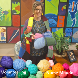 A staff member from Nurse Maude, with their Knit for Purpose blankets