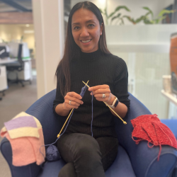 Haidee, from Volunteering Mid & South Canterbury, knitting a peggy square