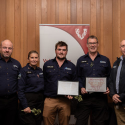 Five members of the Selwyn Response team with their Award, in front of the Volunteering Canterbury banner