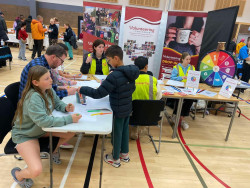 VolCan stall at Selwyn CultureFest, busy with attendees decorating paper bags