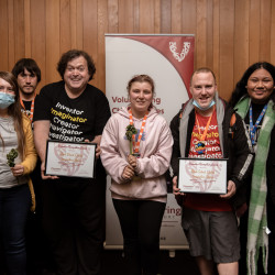 Representatives from Imagination Station and their Award, in front of the Volunteering Canterbury banner