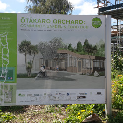 An outdoor sign in the Otakaro Orchard displaying an artist's impression of the finished building & information about the mission of the organisation