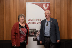 Greg Wright and a supporter, in front of the Volunteering Canterbury banner