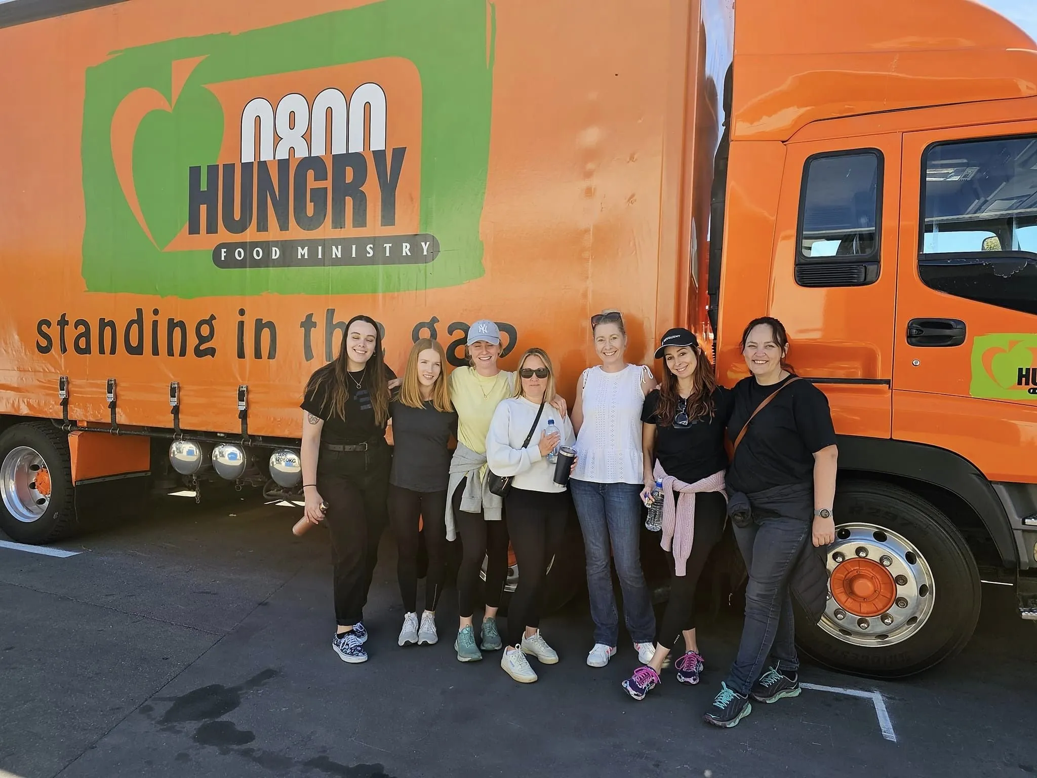 A staff team from Sequent, standing besides the 0800 Hungry delivery truck