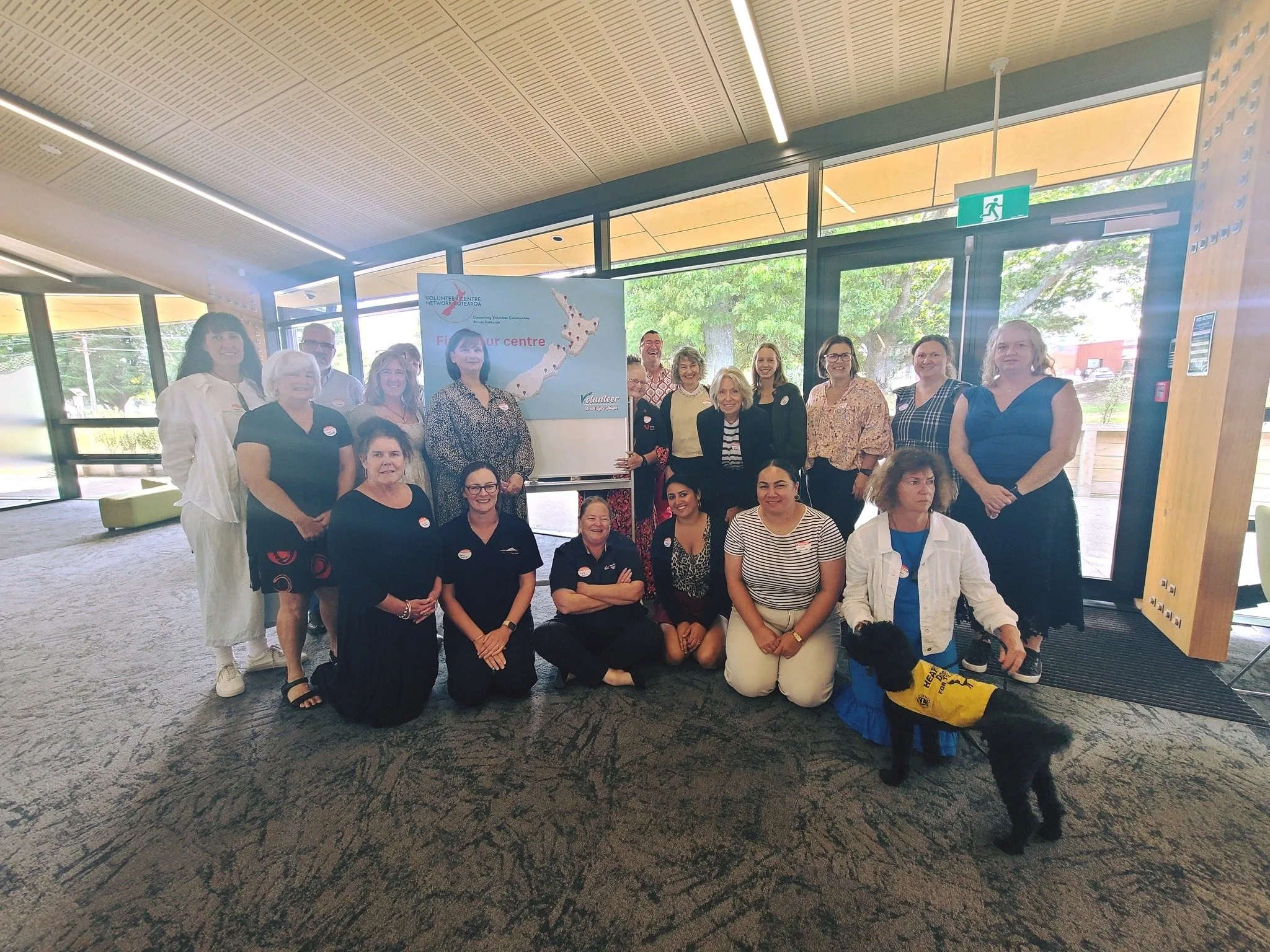 Representatives of the VCNA sitting at tables around a room, for the 2025 Hui