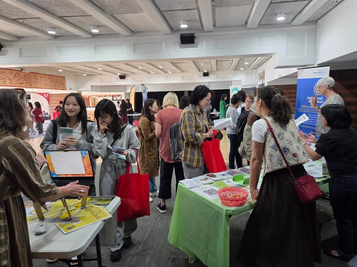 Image of the 2026 Newcomers Volunteer Expo, showing a large room full of visitors looking at information and talking to organisations at their stalls.