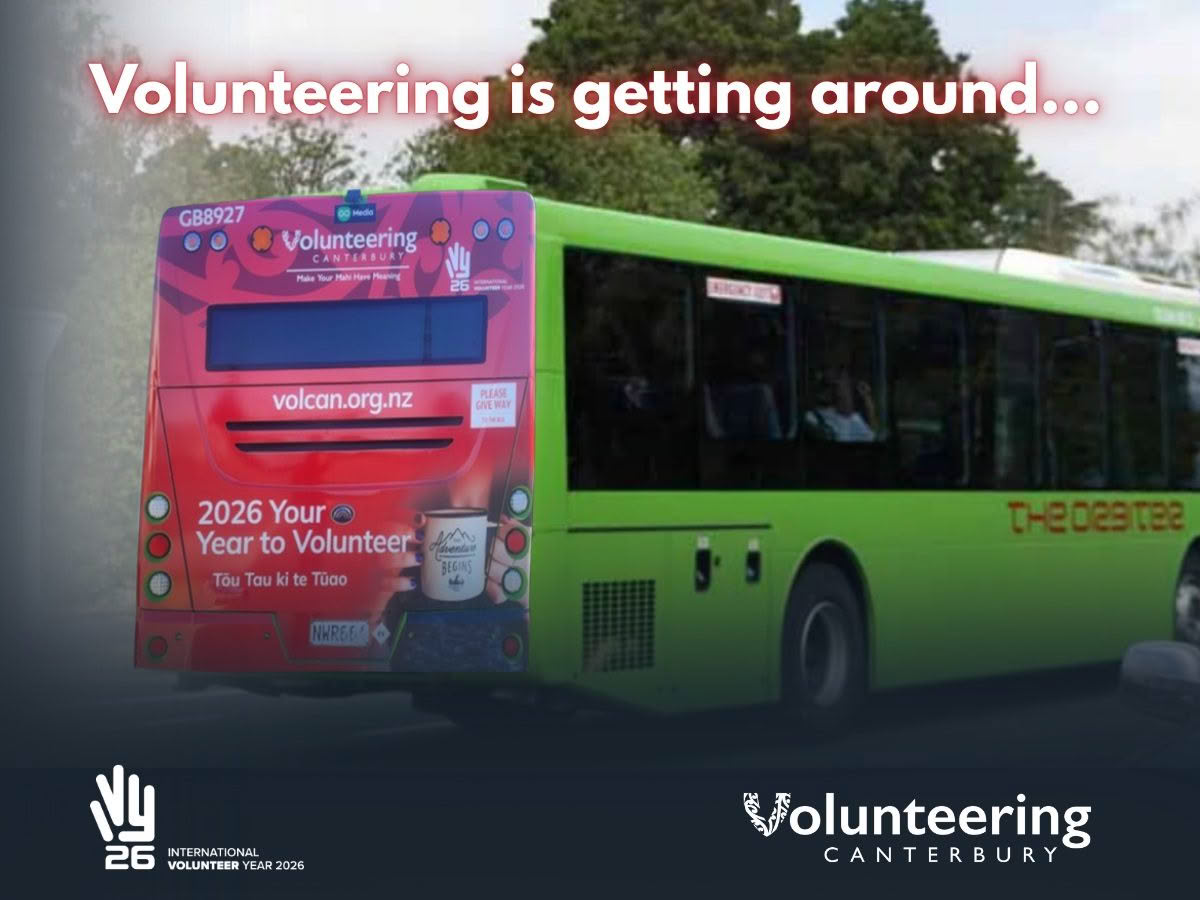 A promotional graphic featuring a Volunteering Canterbury advertisement on the back of a green bus, with the headline “Volunteering is getting around…” and International Volunteer Year 2026 branding. The bus advertisement promotes 2026 as “Your Year to Volunteer” and includes Volunteering Canterbury’s website and logos.