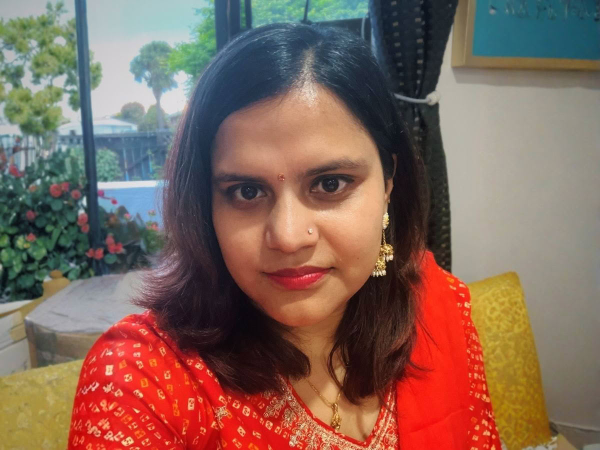 Shrestha sitting on a sofa